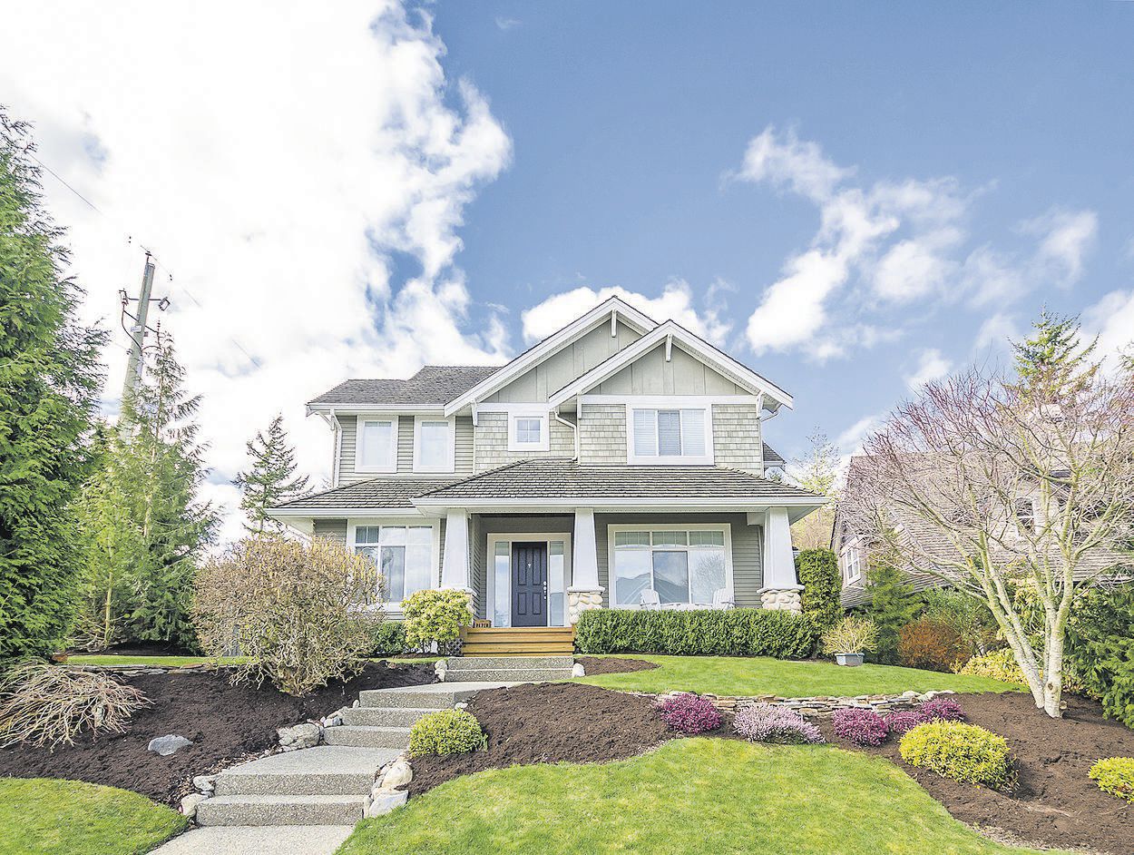 Luxury house with beautiful landscaping on a sunny day. Home exterior design.